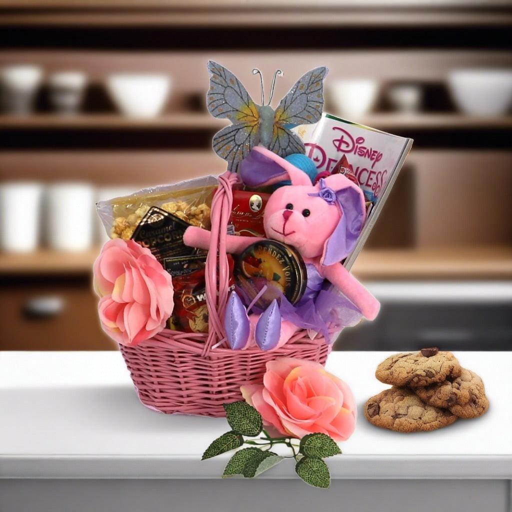 Pink wicker princess gift basket with plush bunny, butterfly topper, and cookies on table