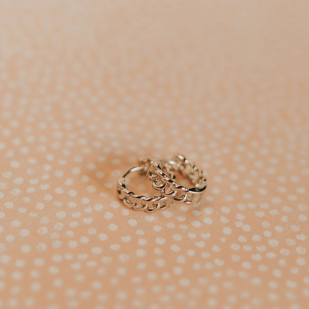 Pair of gold Peri hoops with a raised chain-link texture.