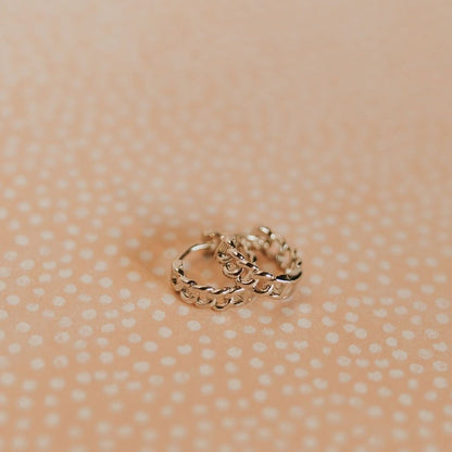 Pair of gold Peri hoops with a raised chain-link texture.