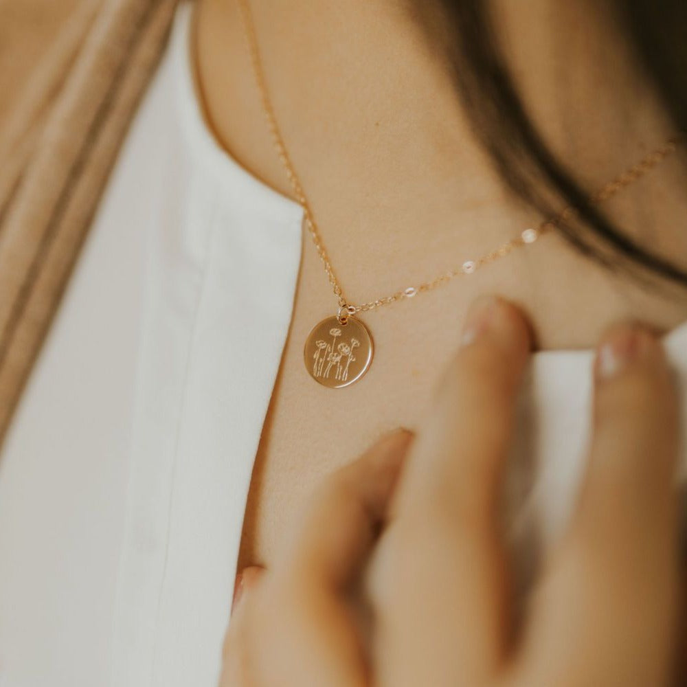 Gold-tone Poppy Necklace worn with a small round flower-engraved pendant