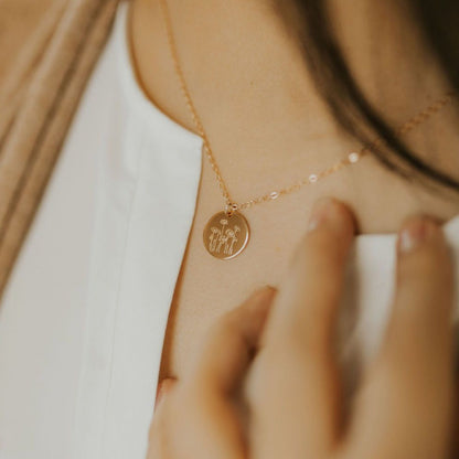 Gold-tone Poppy Necklace worn with a small round flower-engraved pendant