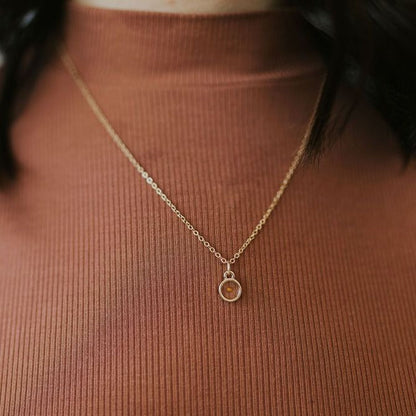 Mustard seed faith necklace worn with a small round pendant
