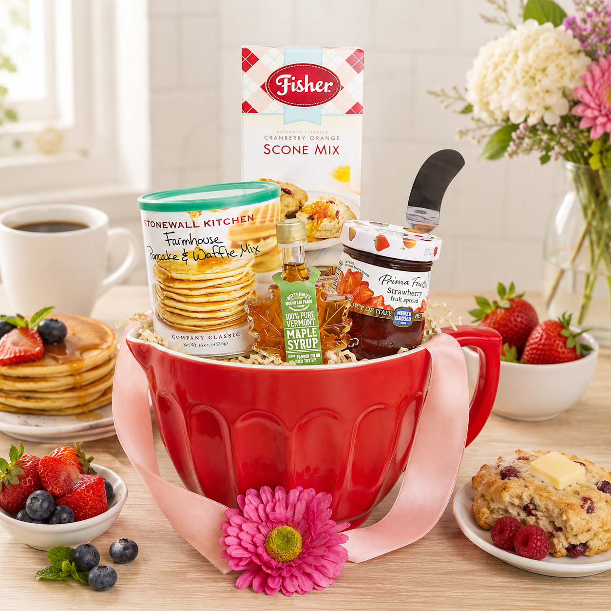 Red ceramic mug gift basket with baking mix, syrup, and assorted breakfast items