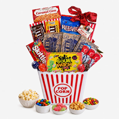 Movie night gift basket with red striped popcorn bucket and assorted packaged candies