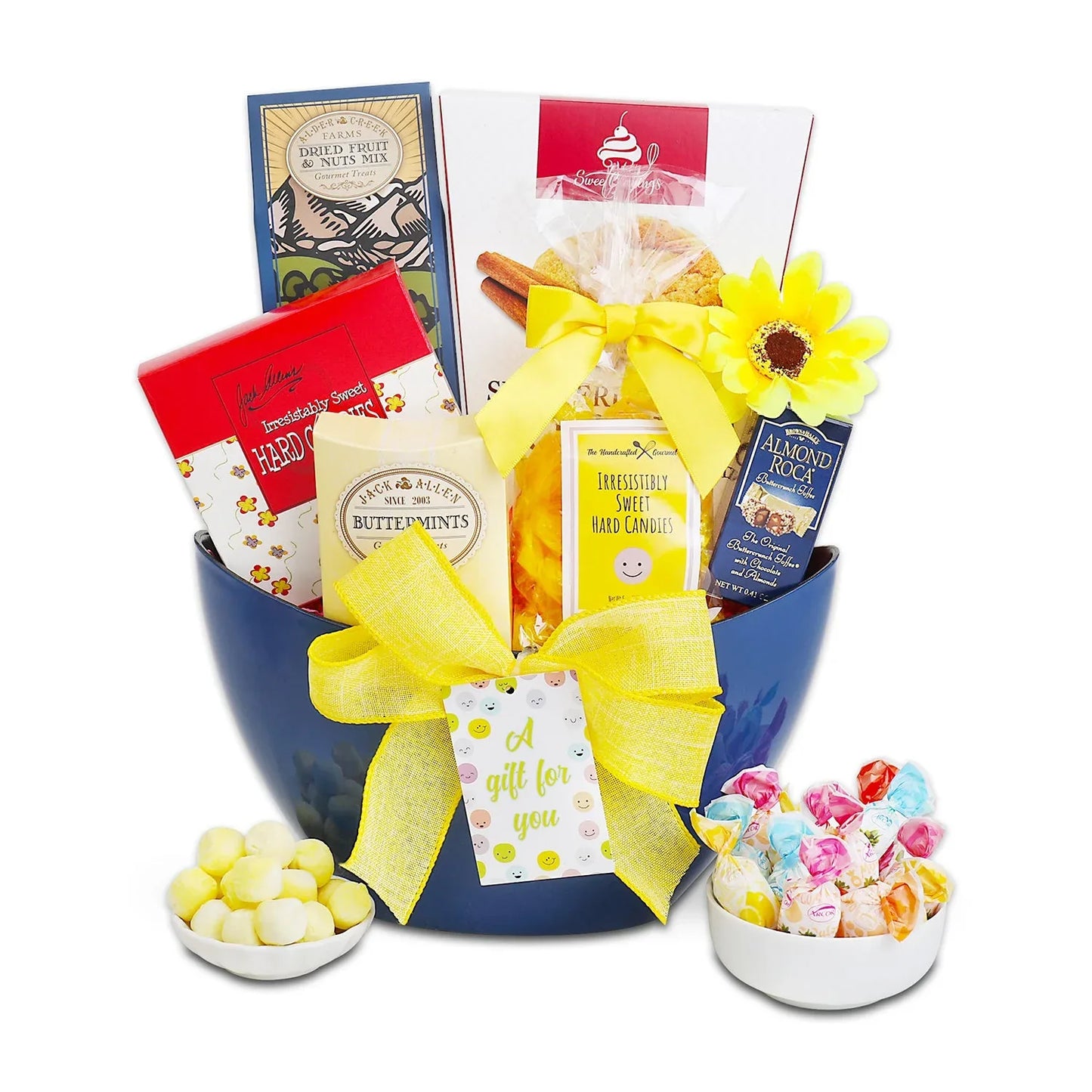 Blue gift tote with yellow bow, assorted candy, cookies, and jelly candies