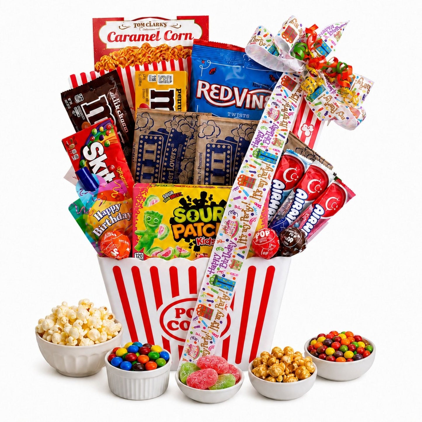 Movie night gift basket holding caramel corn, sour candy, and assorted snack bowls