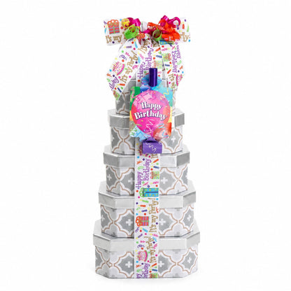 Stacked birthday treat tower with gray patterned boxes and colorful ribbon bow