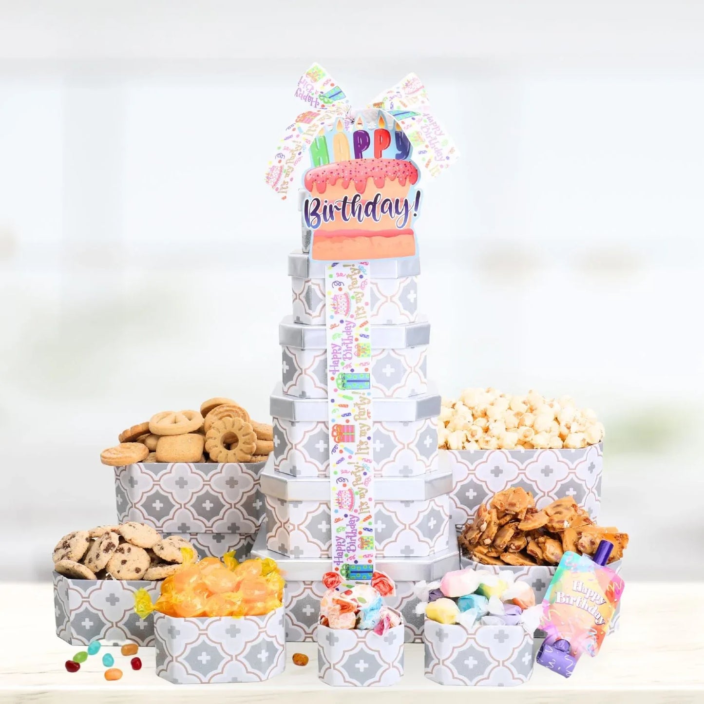 Happy Birthday treat tower with snack-filled boxes and colorful ribbon topper