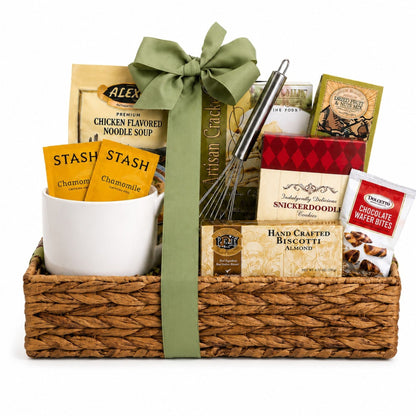 Gift basket with woven base and green bow, noodle soup, biscotti, and chocolate snack bags
