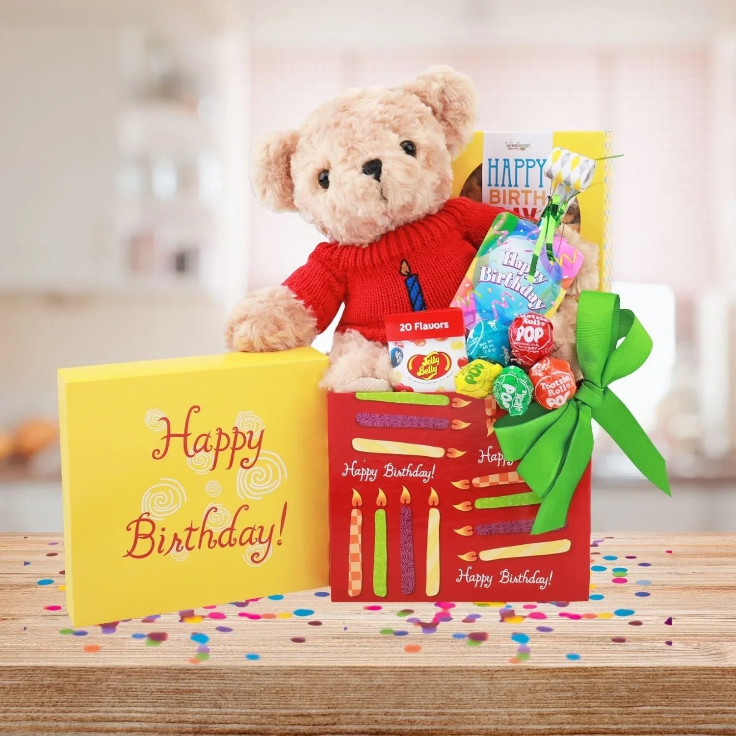 Plush teddy in red sweater on Happy Birthday gift box with candles print and candy packs