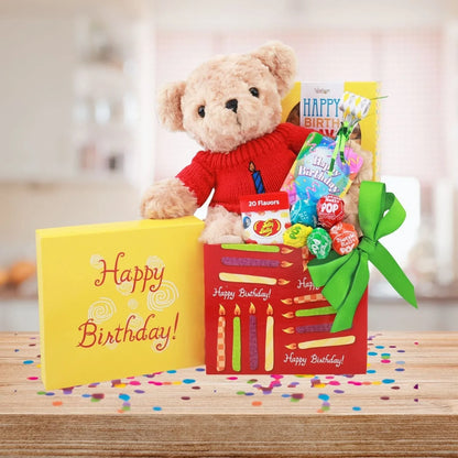 Plush teddy in red sweater on Happy Birthday gift box with candles print and candy packs