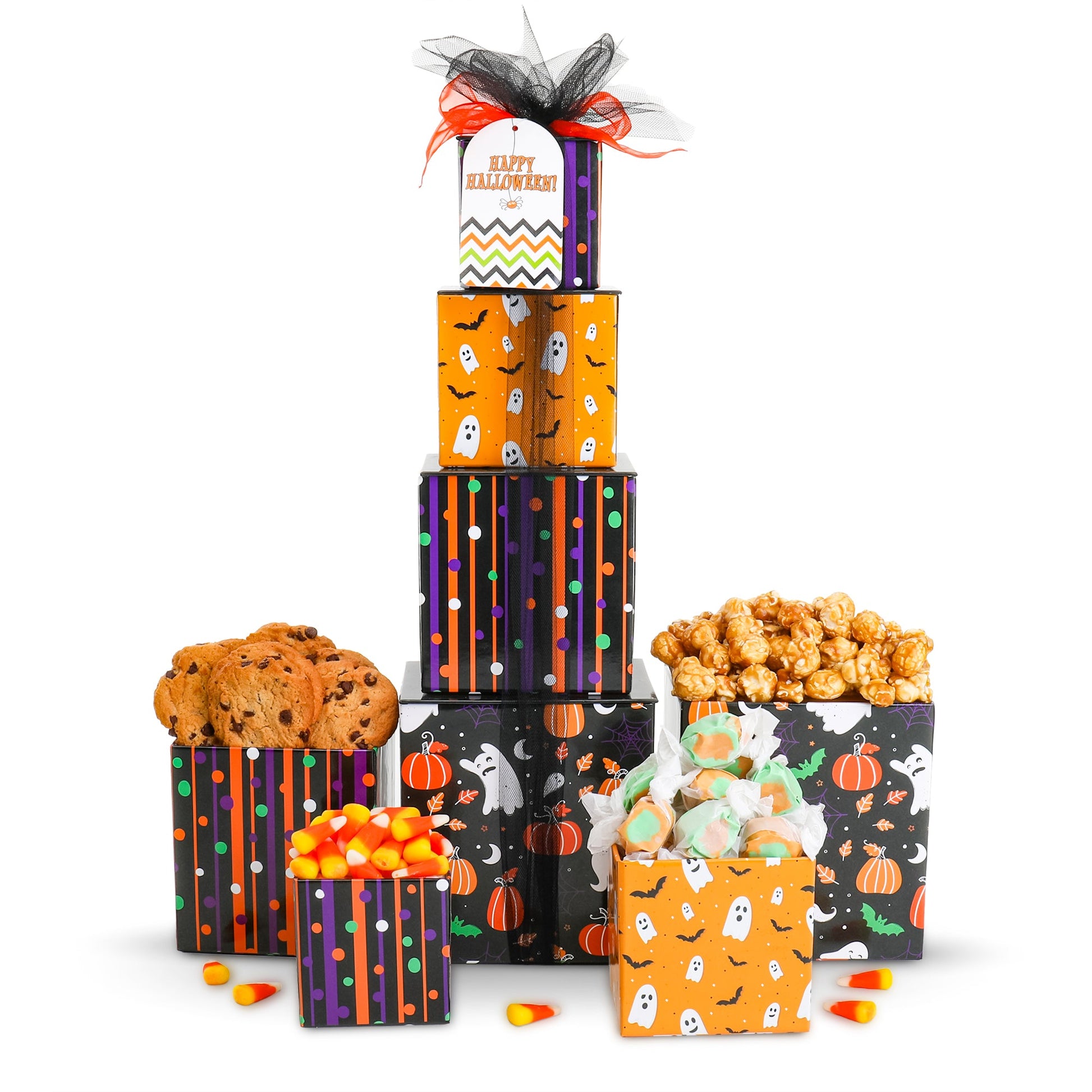 Halloween treat gift tower with four stacked boxes, cookies, candies, and popcorn in front.