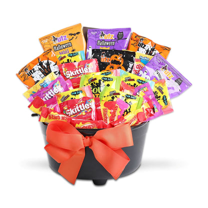 Halloween treat gift basket with colorful candy bags in black cauldron and orange bow