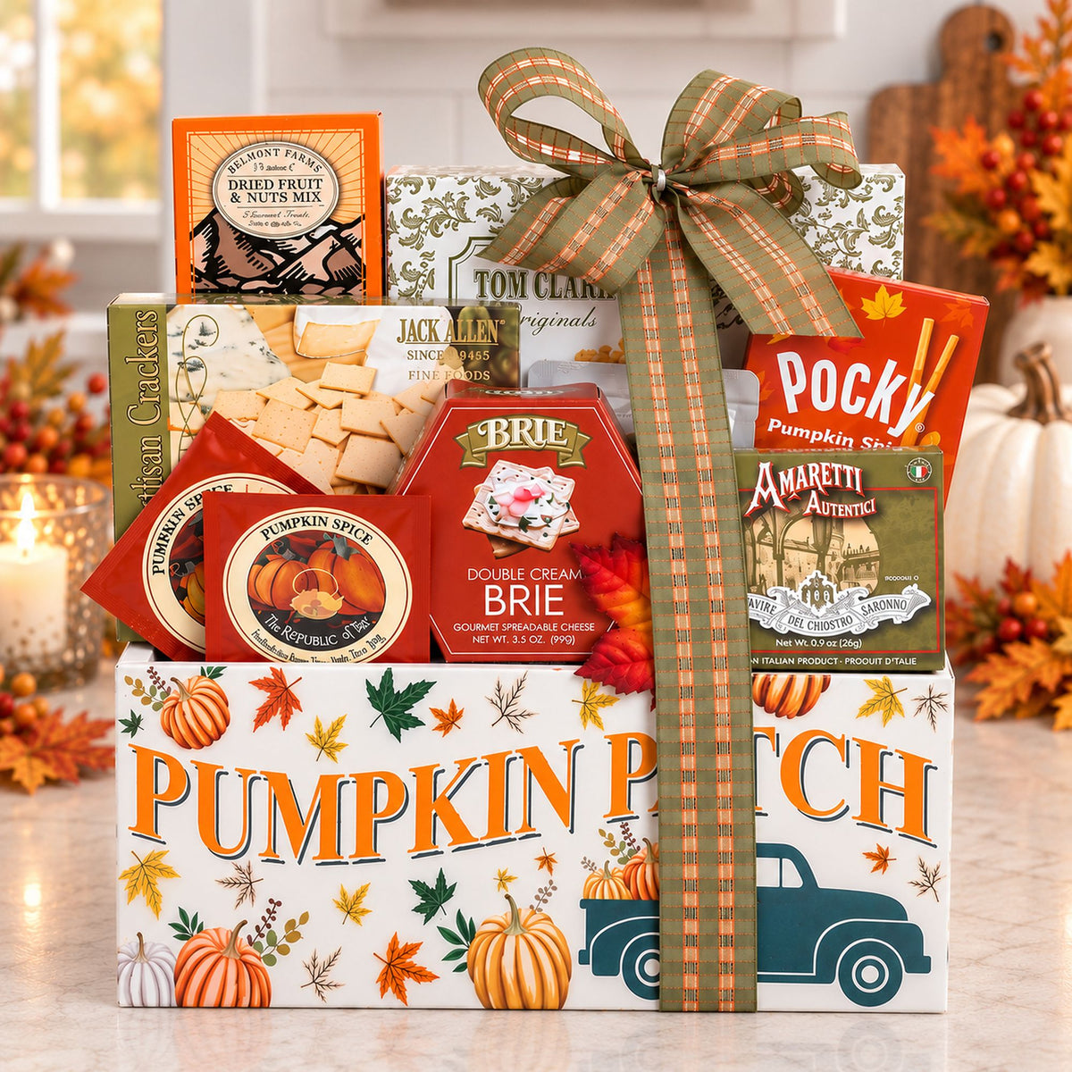 Fall gift basket with pumpkin-themed boxes, wrapped with a plaid ribbon bow
