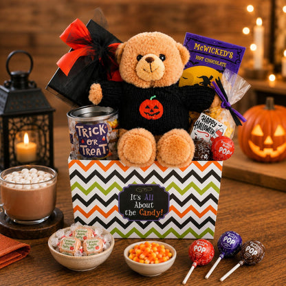 Halloween gift basket with teddy bear, candy, and orange jack-o'-lantern on zigzag bag