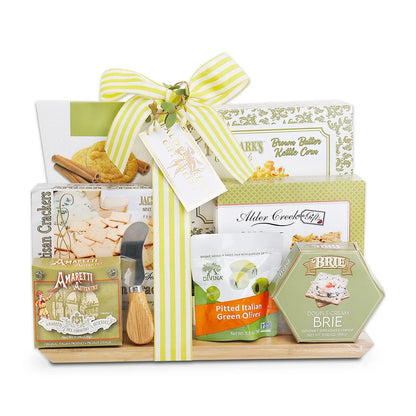 Brie cheese and pitted green olive charcuterie gift with crackers, in wrapped box