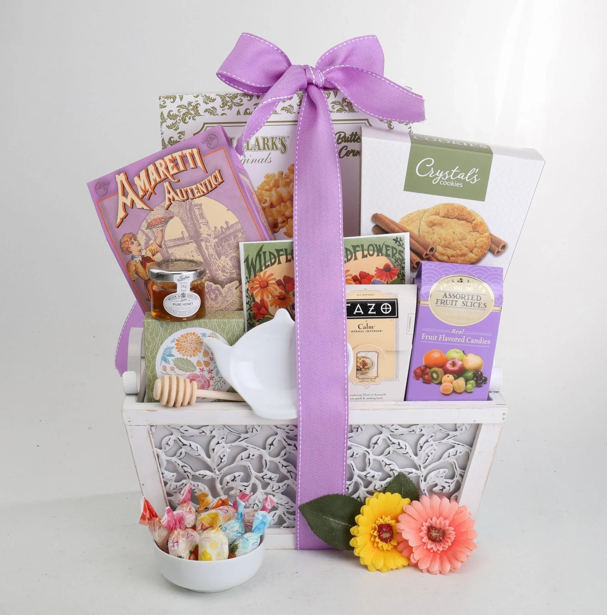 Garden of Indulgence gift basket with purple ribbon and assorted treats and cookies