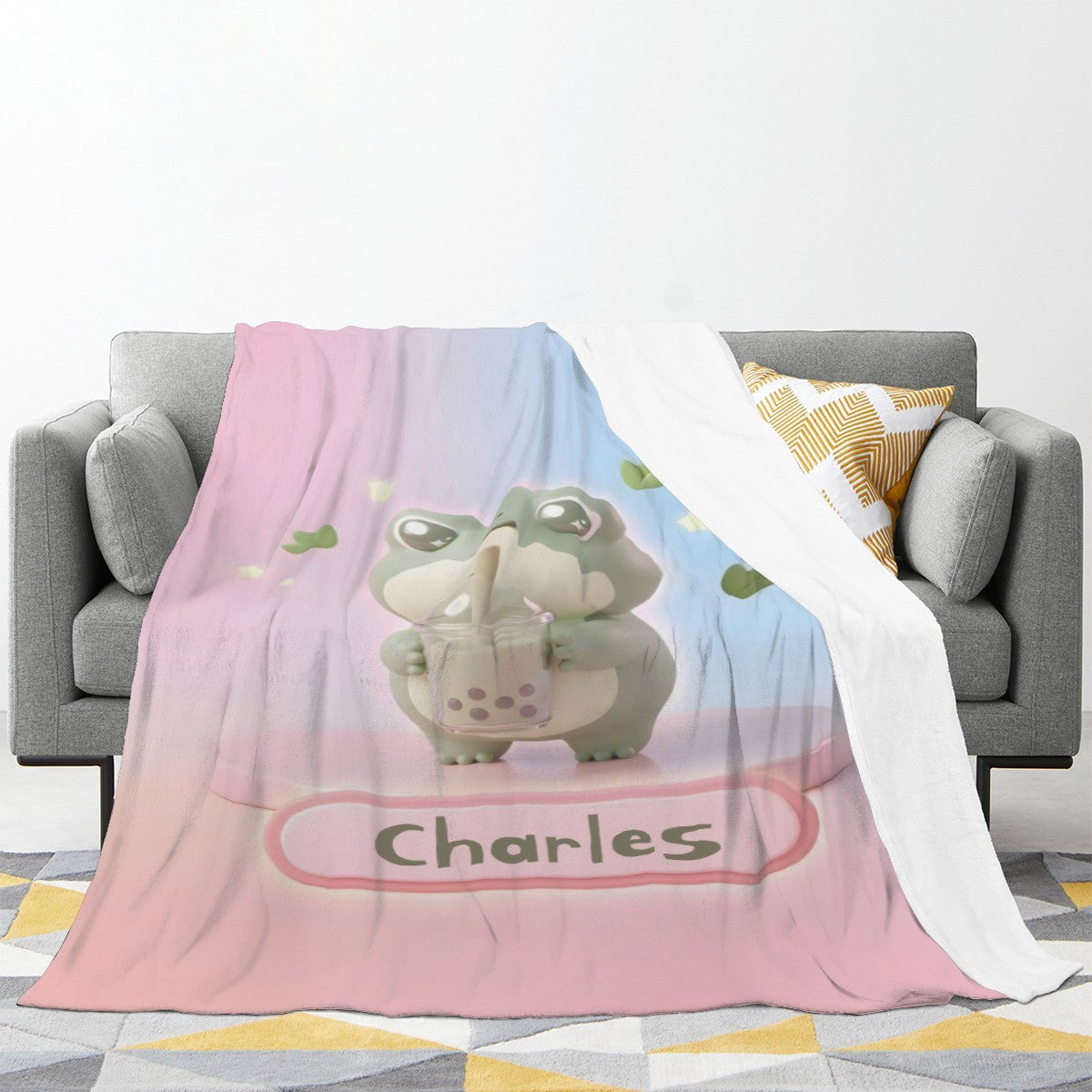 Frog character blanket draped on sofa, pink and blue gradient with frog illustration