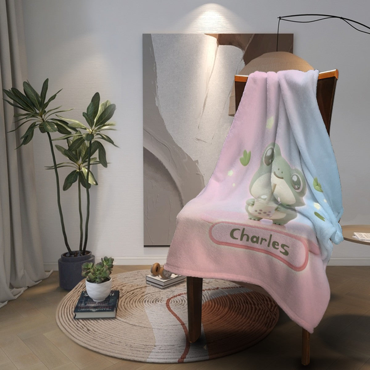 Frog cartoon blanket spread over chair, pink and blue gradient with frog design