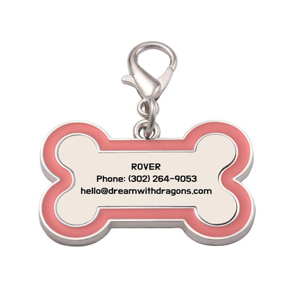 Pink and silver bone-shaped dog tag keychain with metal ring and contact text
