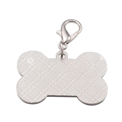 Silver bone-shaped dog tag keychain with metal ring and textured surface