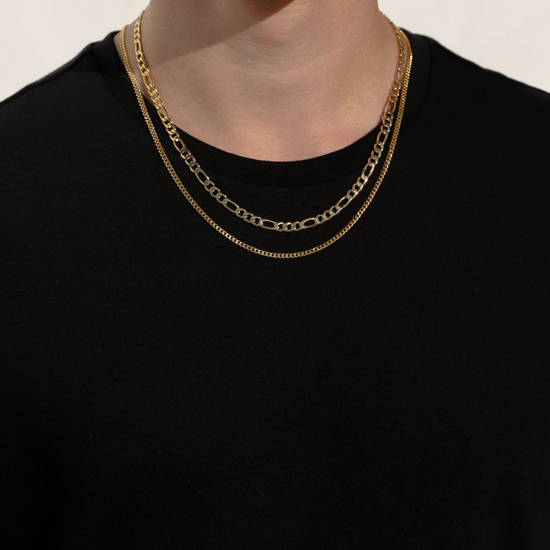 Layered gold-tone Figaro chain necklaces with oval links
