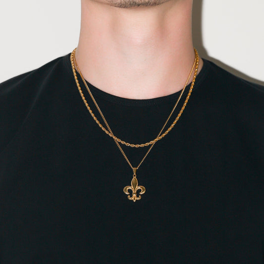Gold fleur-de-lis pendant on two rope chains, worn as a necklace