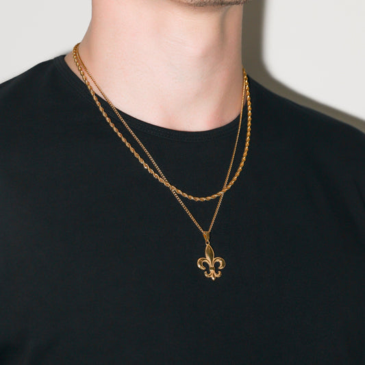 Gold fleur-de-lis pendant on two rope chains, worn close to the neck