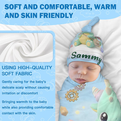 Soft blue swaddle blanket and green dragon hat worn by baby.
