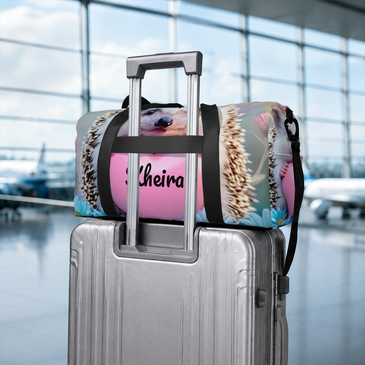 Hedgehog print duffel bag attached to a rolling suitcase with rear luggage strap