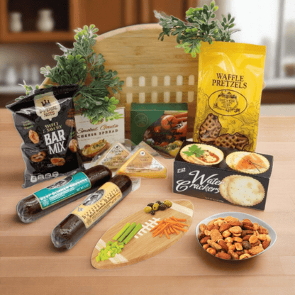 Football-shaped wooden cutting board gift set with snack packages, cheese, and crackers