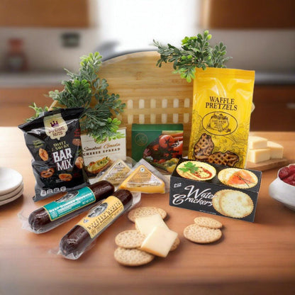 Football-shaped wooden cutting board gift set with snack bags, cheese, and crackers