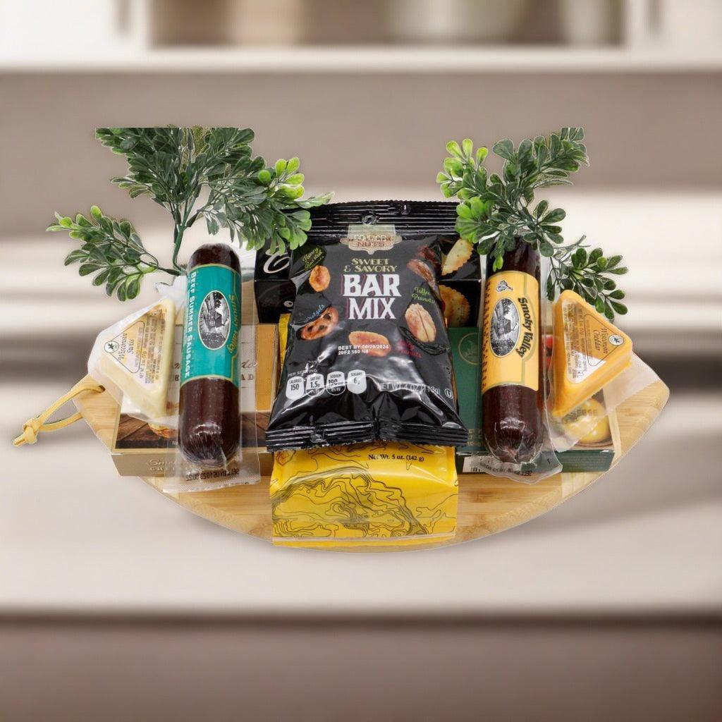 Football-shaped wooden cutting board gift set with snack packages and cheese on top