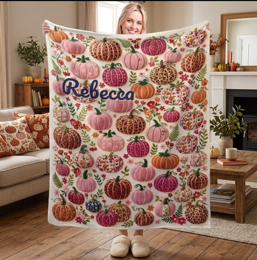 Personalized fleece throw blanket with pumpkin-floral pattern and name Rebecca, held up