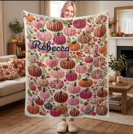 Personalized fleece throw blanket with pumpkin-floral pattern and name Rebecca, held up