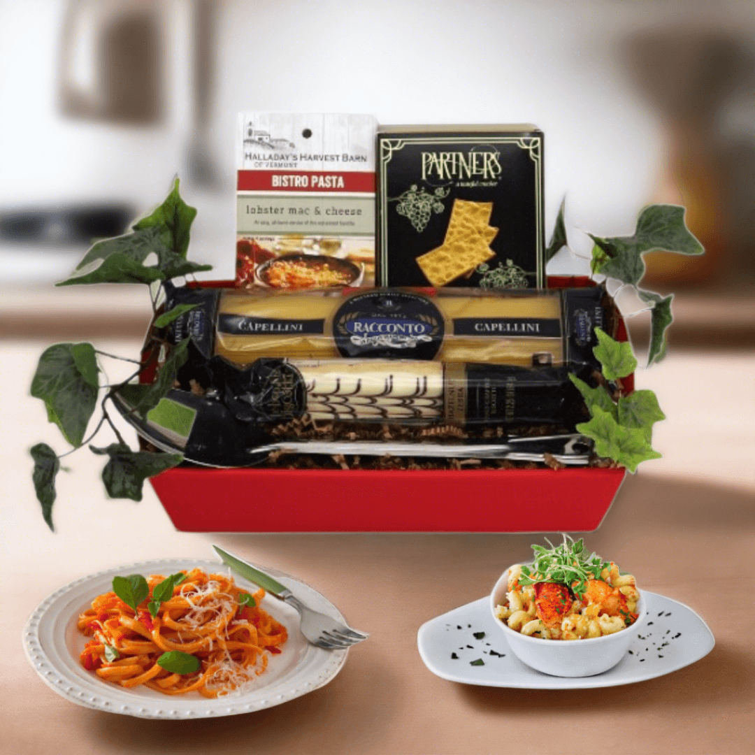 Red Italian gourmet gift basket with pasta packages, sauce box, and two served dishes