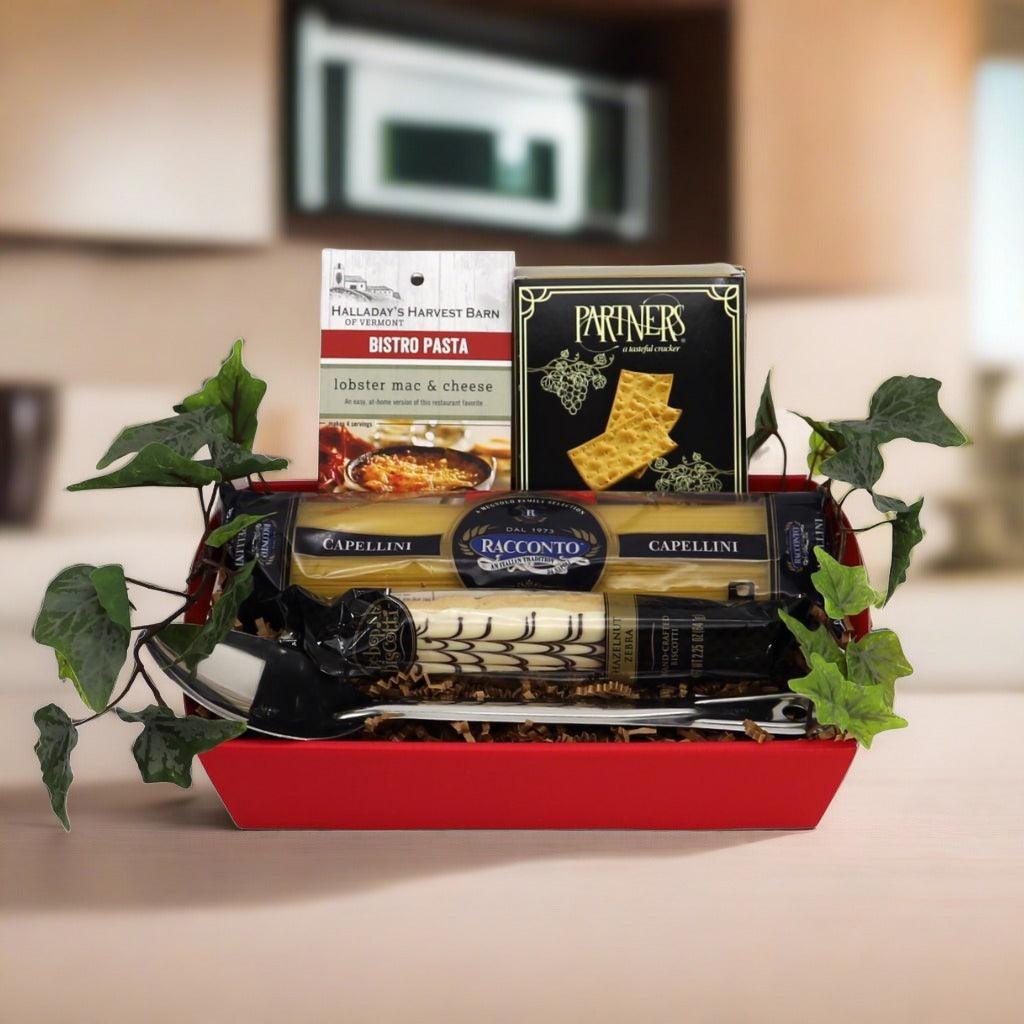Red Italian gourmet gift basket with three pasta packs and two boxed pasta products