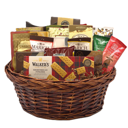 Wicker gift basket filled with assorted chocolate and shortbread cookies and candy bags