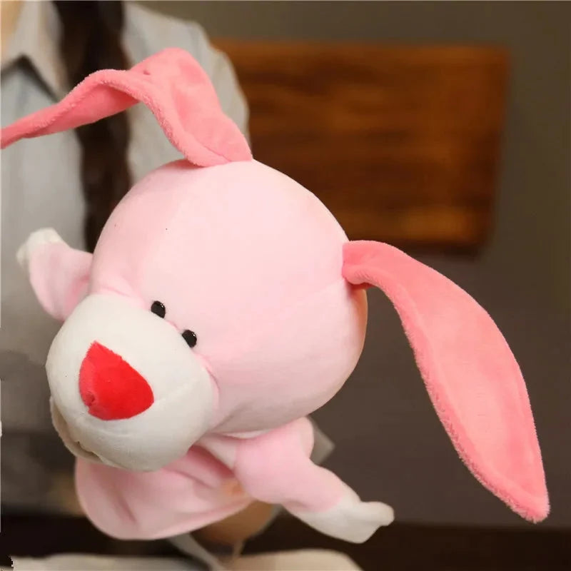 Pink plush finger puppet rabbit with floppy ears and red nose