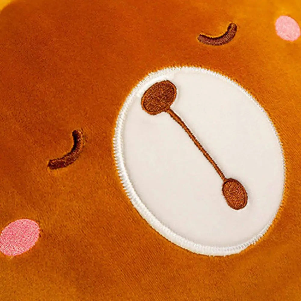 Orange plush cushion blanket with white round patch and brown stitched nose details