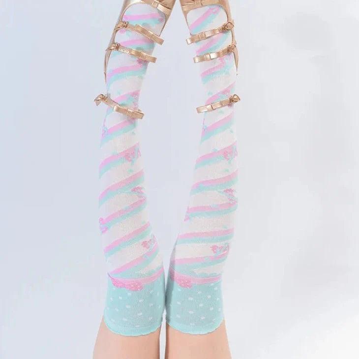 Knee-high socks with pastel blue base, rainbow stripes, and tiny heart dots