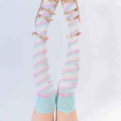 Knee-high socks with pastel blue base, rainbow stripes, and tiny heart dots