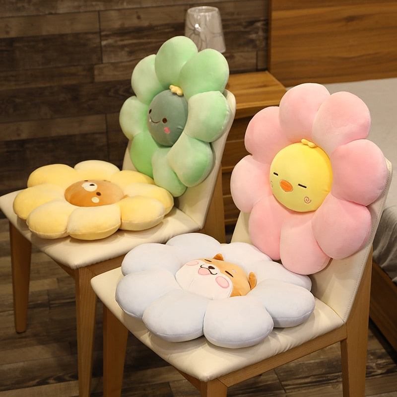 Plush flower pillows in green, pink, yellow, and white with cute animal faces
