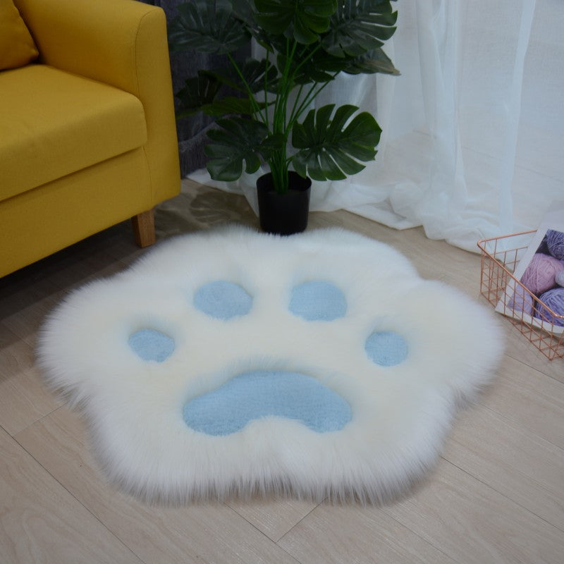 White faux fur round cat paw area rug with light blue paw pad details