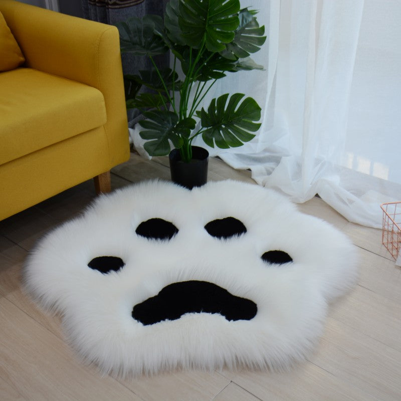 White faux fur cat paw area rug with black paw pad details
