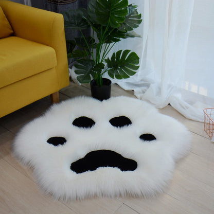 White faux fur cat paw area rug with black paw pad details