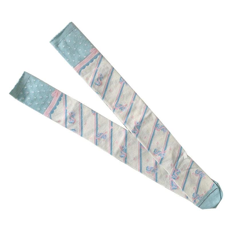 Pair of knee-high socks with light blue top, rainbow stripes, and small motif print