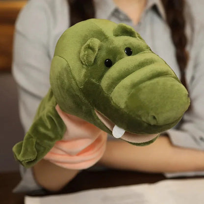 Green crocodile finger puppet plush with small black eyes and white belly