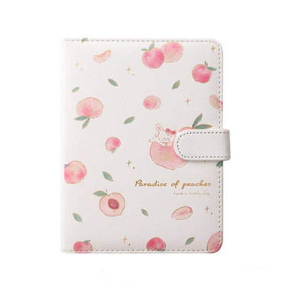 White and pink peach notebook cover with scattered fruit illustrations and a side strap