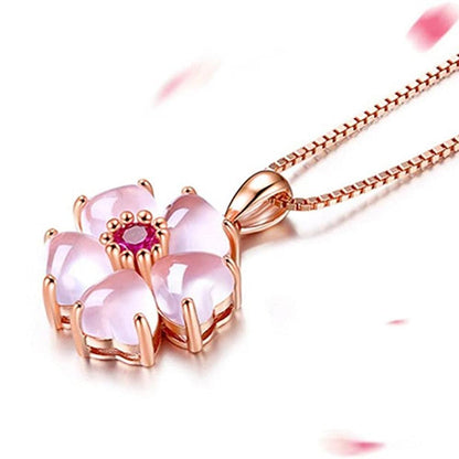 Pink sakura pendant necklace with rose-gold chain and scalloped pink petal petals.